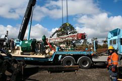 The cranes haul the derrick up.