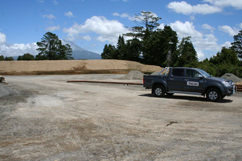 A TAG truck in the foreground and Mt. Taranaki behind the trees.