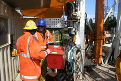 Driller and assistant driller talking over.
